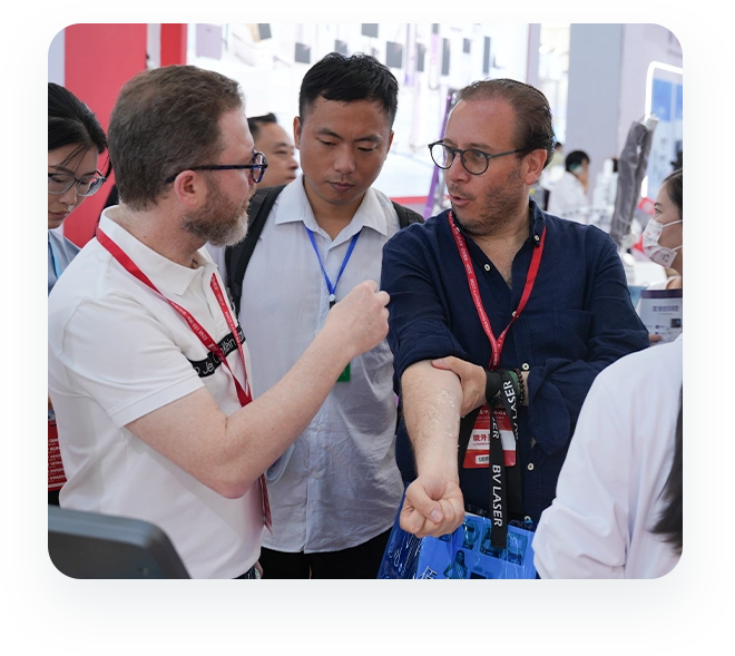 Visitors discussing equipment with the exhibition team